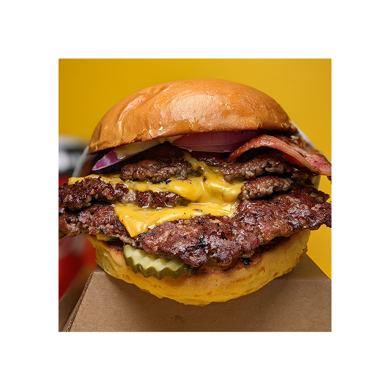 A large close up image of a Burger Villains burger - the classic cheeseburger, with triple beef patties